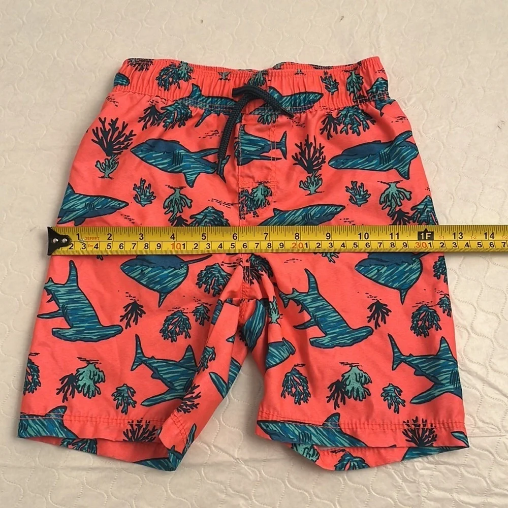 Old Navy coral and teal shark print lined swim trunks